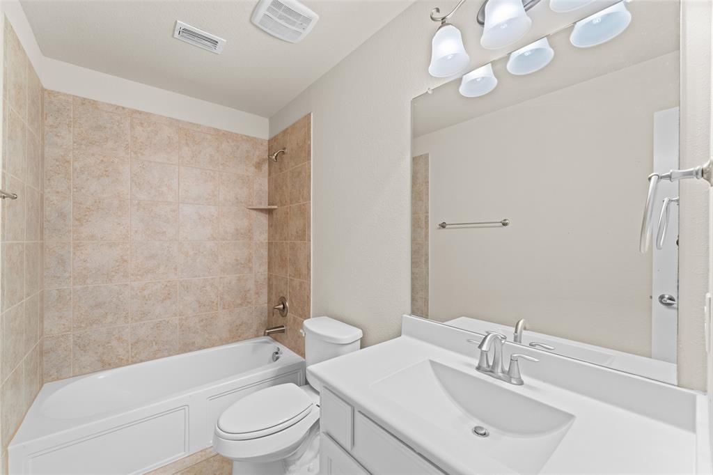 1425 Barrolo Drive McLendon-Chisholm, TX 75032 - Photo 34 of 38 a bathroom with a sink a toilet and shower