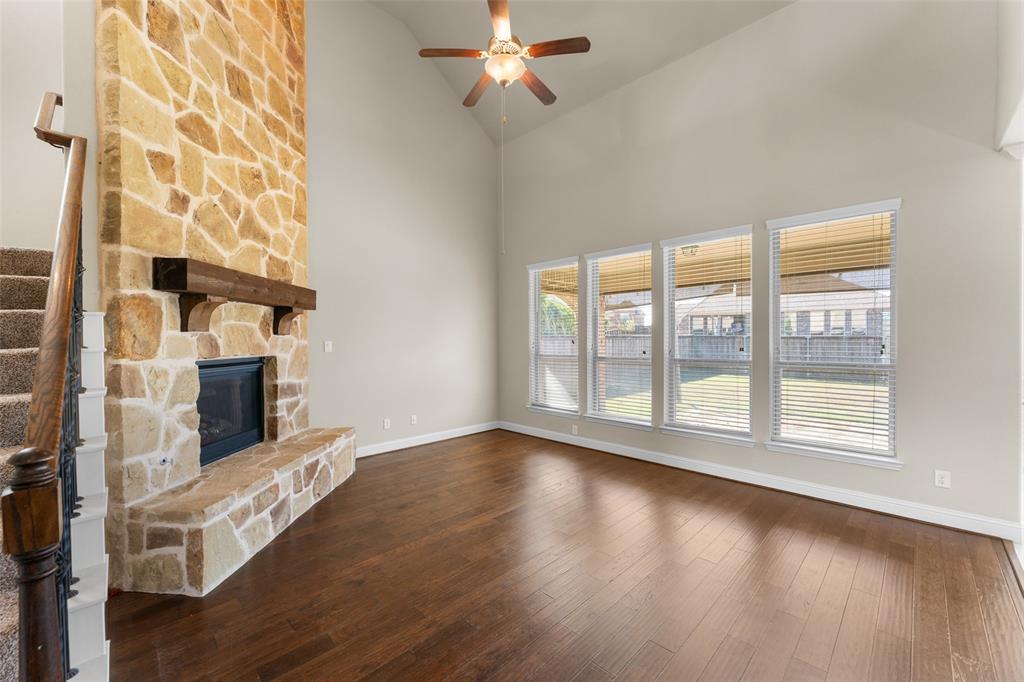 1425 Barrolo Drive McLendon-Chisholm, TX 75032 - Photo 7 of 38 a view of wooden floor fire place and windows in an empty room