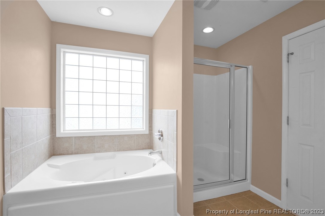 66 Pender Road Spring Lake, NC 28390 - Photo 26 of 35 a bathroom with a bathtub and a shower
