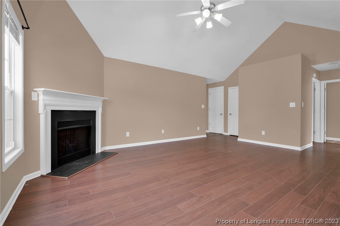 66 Pender Road Spring Lake, NC 28390 - Photo 8 of 35 a view of an empty room with wooden floor and a fireplace