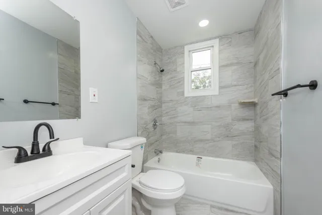 a bathroom with a sink toilet and a bathtub