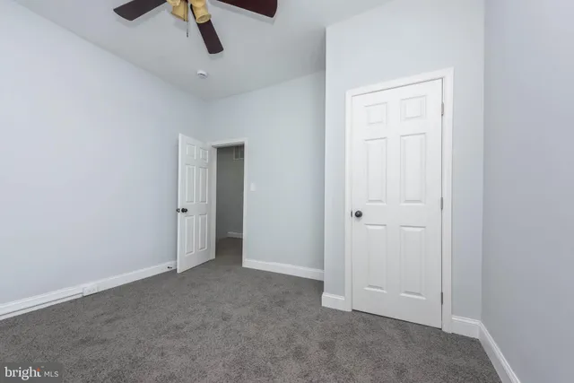 an empty room with ceiling fan