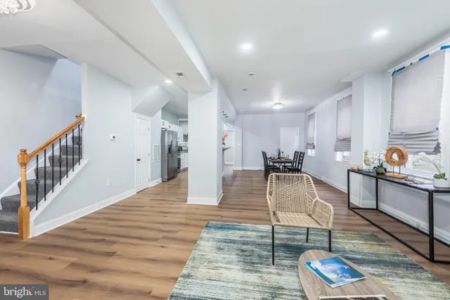 a view of living room and kitchen with wooden floor