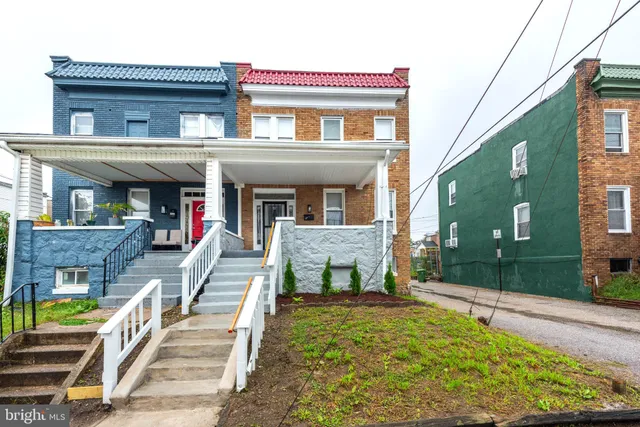 a view of a house with a balcony and front door