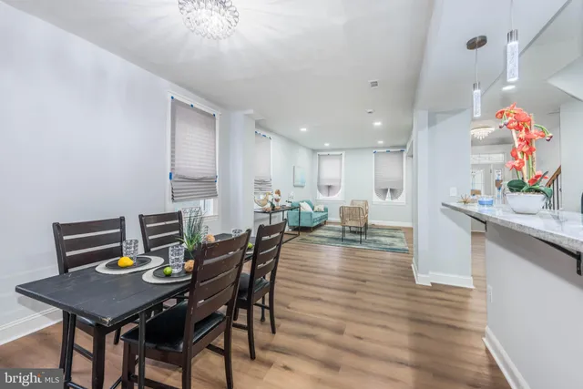 a view of a dining room with furniture and wooden floor