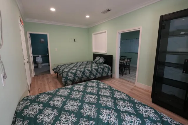 a bedroom with a large bed and a walk in closet