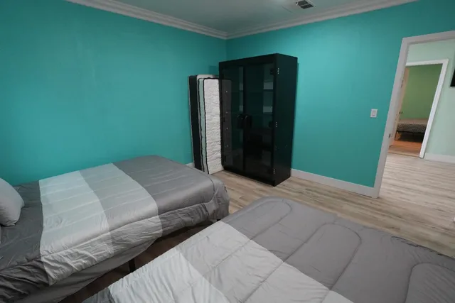 a bedroom with a bed and a mirror