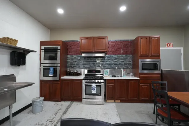 a kitchen with stainless steel appliances granite countertop a stove sink and cabinets