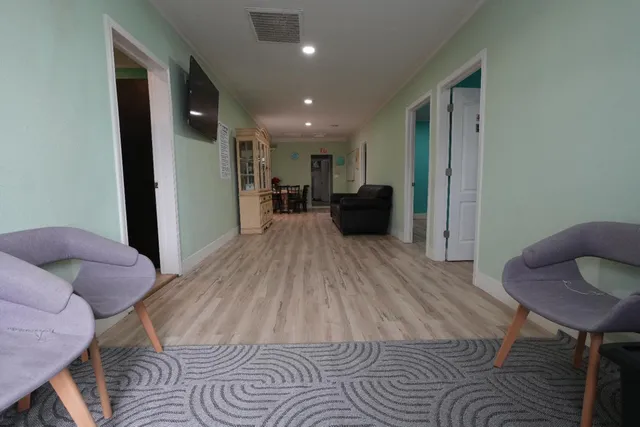 a view of a livingroom with furniture and lounge chair