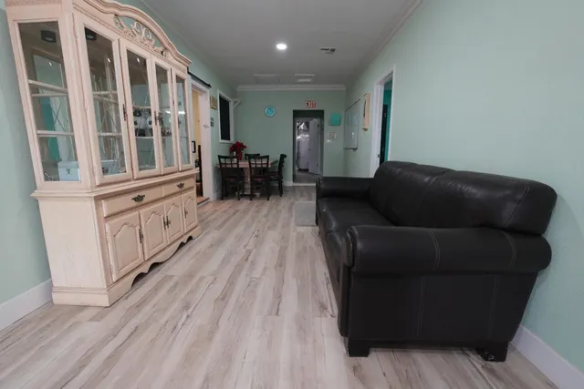 a living room with furniture and wooden floor