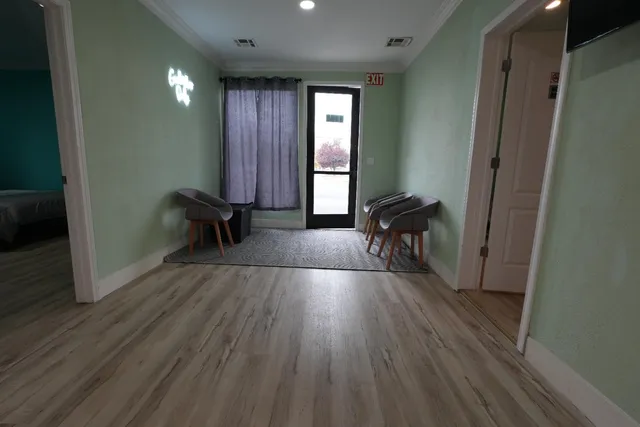 a view of a room with wooden floor and a window