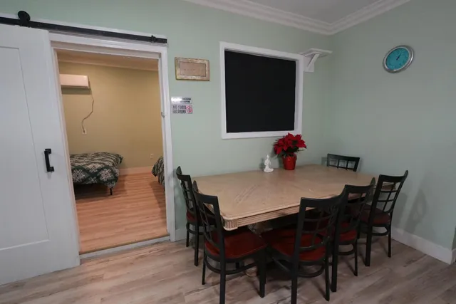 a view of a dining room with furniture and wooden floor