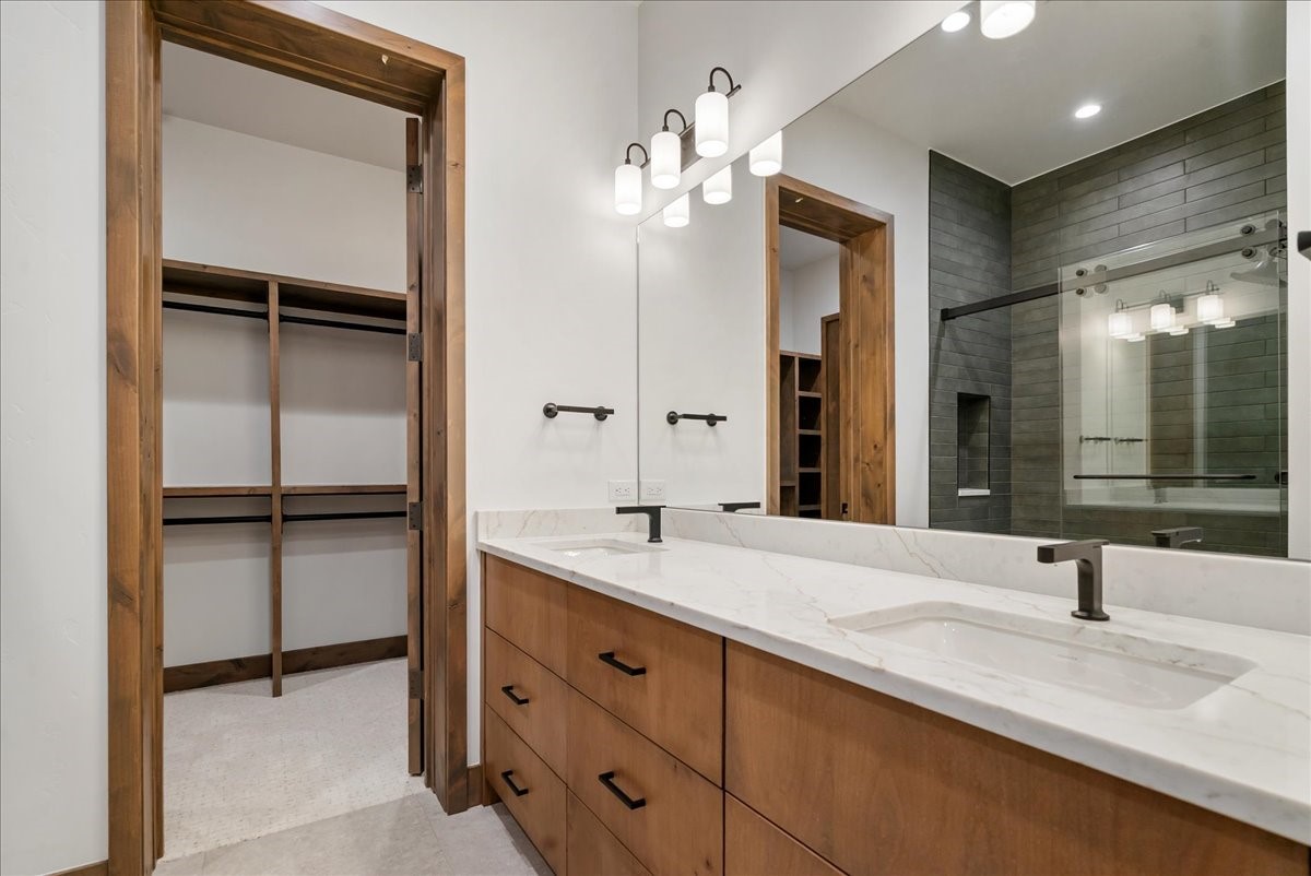 1615 Golden Eagle Road Silverthorne, CO 80498 - Photo 35 of 47 a bathroom with a double vanity sink and a mirror
