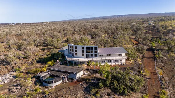 an aerial view of a house with a yard