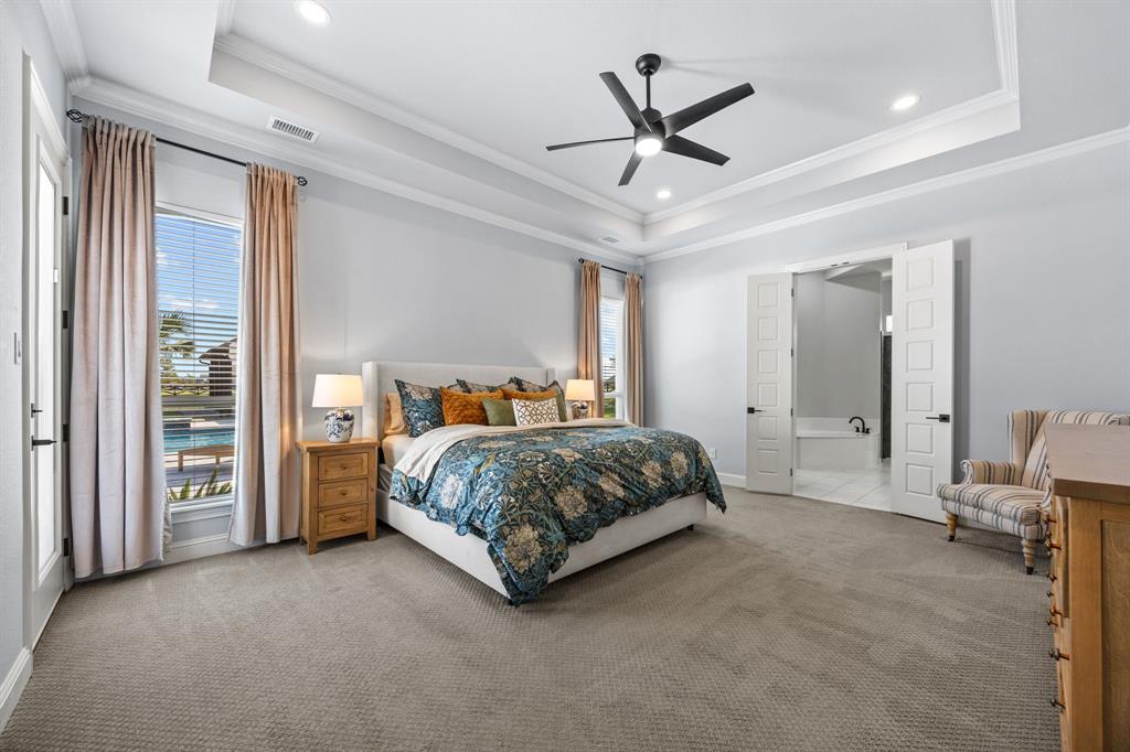 5707 Florance Road Northlake, TX 76226 - Photo 12 of 31 a spacious bedroom with a large bed and a chandelier