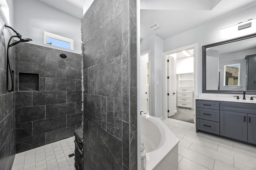 5707 Florance Road Northlake, TX 76226 - Photo 13 of 31 a spacious bathroom with a bathtub shower sink and mirror