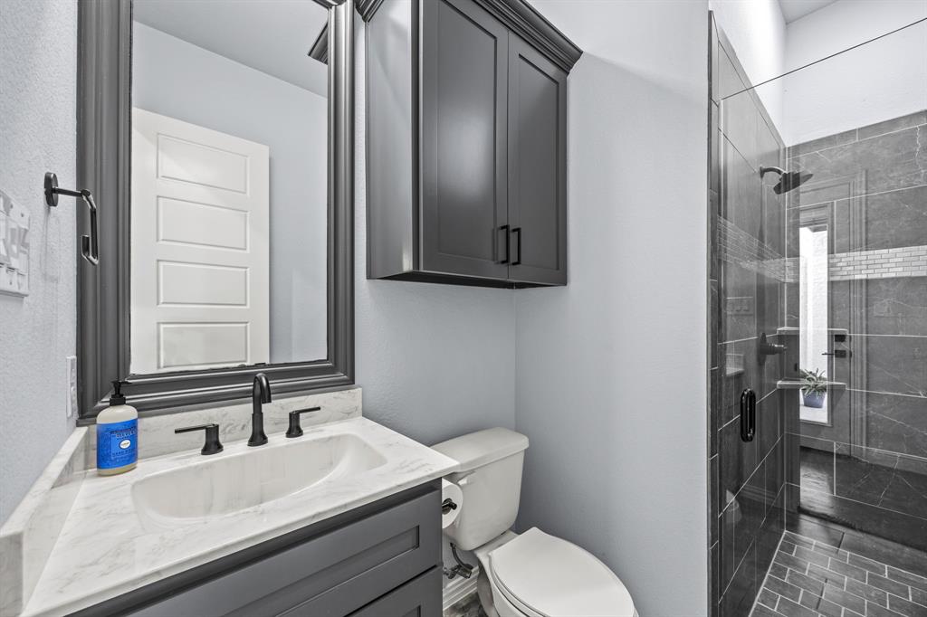 5707 Florance Road Northlake, TX 76226 - Photo 18 of 31 a bathroom with a sink toilet and shower