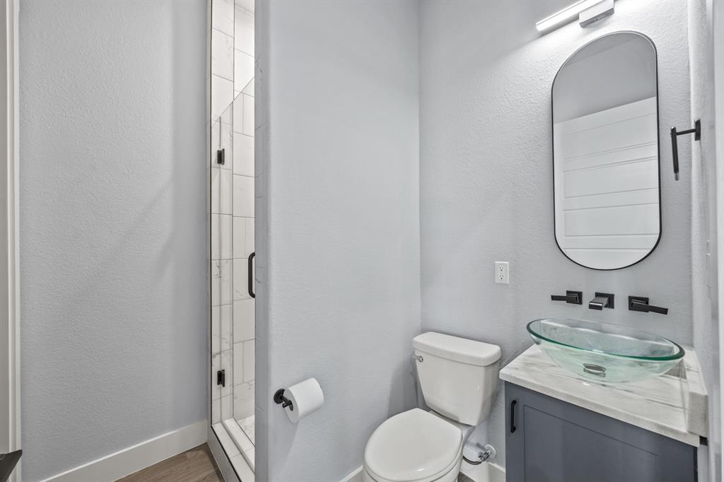 5707 Florance Road Northlake, TX 76226 - Photo 20 of 31 a bathroom with a granite countertop sink toilet and a mirror