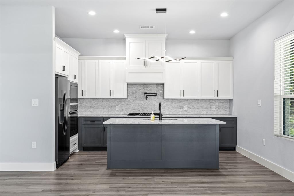 5707 Florance Road Northlake, TX 76226 - Photo 23 of 31 a large kitchen with stainless steel appliances granite countertop a stove and a sink