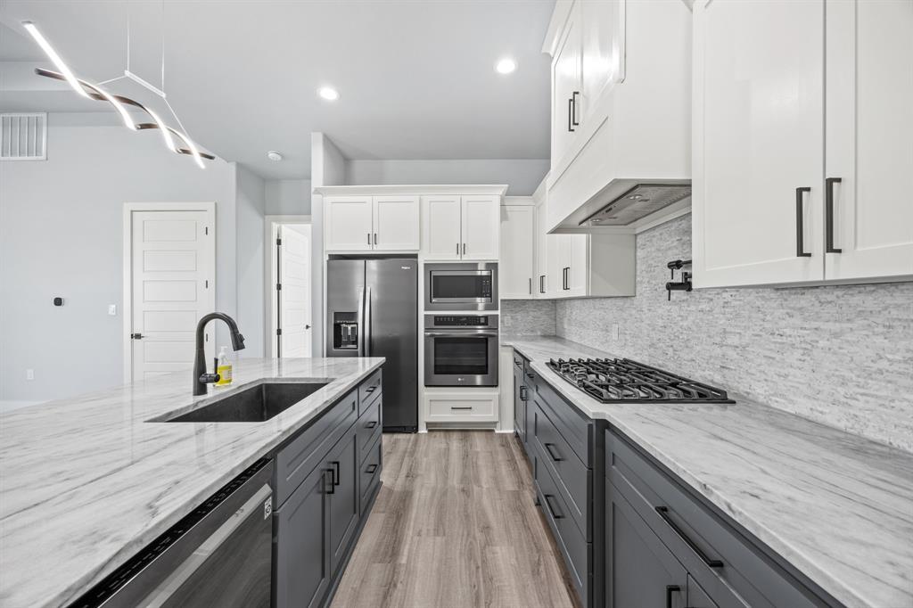 5707 Florance Road Northlake, TX 76226 - Photo 24 of 31 a kitchen with stainless steel appliances granite countertop a sink stove and refrigerator