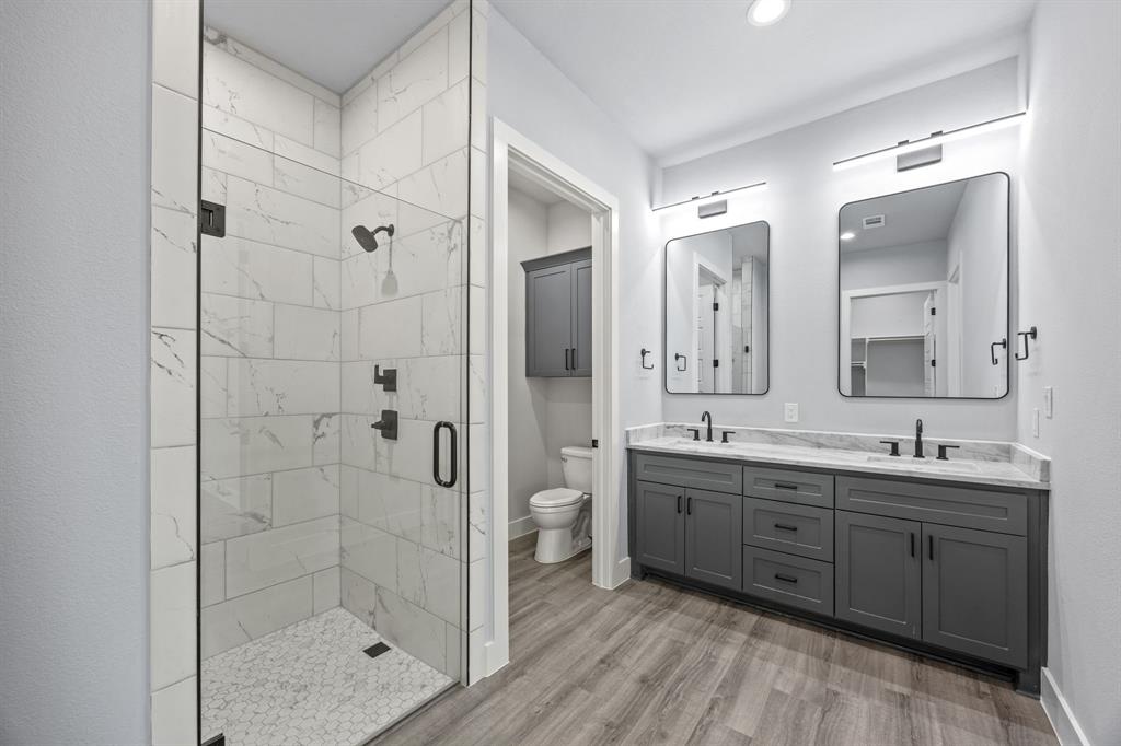5707 Florance Road Northlake, TX 76226 - Photo 26 of 31 a bathroom with a double vanity sink mirror and shower