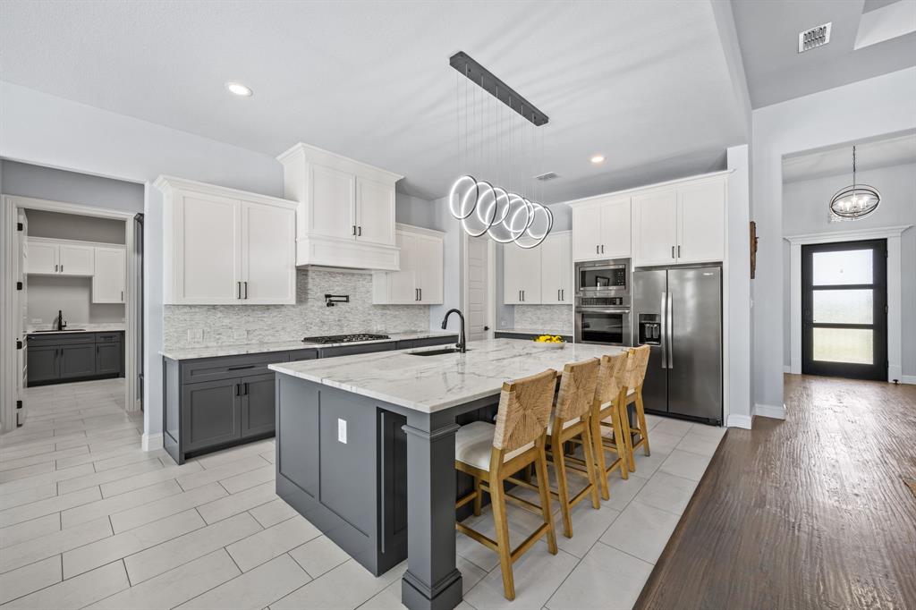 5707 Florance Road Northlake, TX 76226 - Photo 8 of 31 a kitchen with a stove a refrigerator and a sink