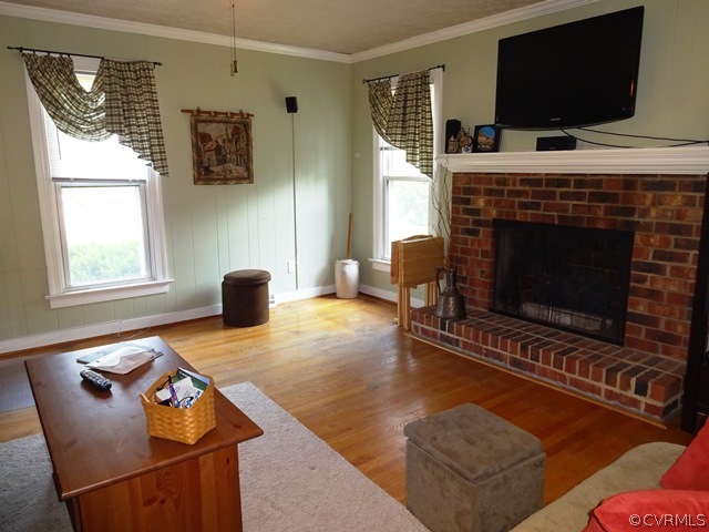 10705 Lunswood Road Chester, VA 23831 - Photo 13 of 22 Family Room with Wood Floors, Fireplace, and Crown