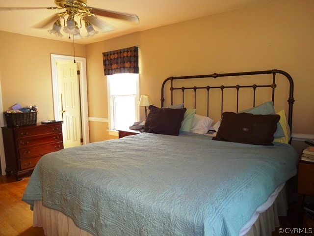 10705 Lunswood Road Chester, VA 23831 - Photo 17 of 22 Master Bedroom with Wood Floor, Ceiling Fan, Chair