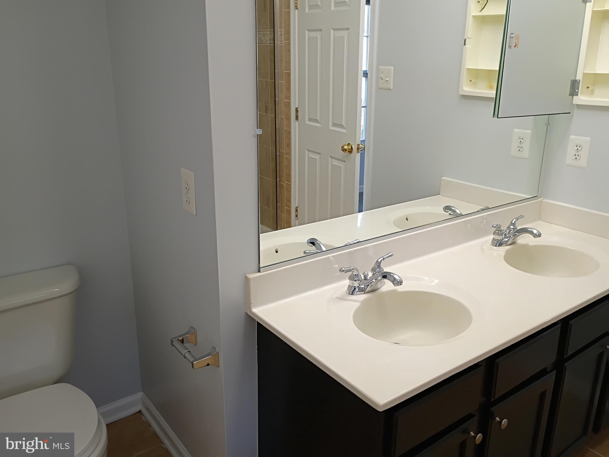 9707 Selfridge Road Baltimore, MD 21220 - Photo 21 of 22 a bathroom with a sink toilet and vanity