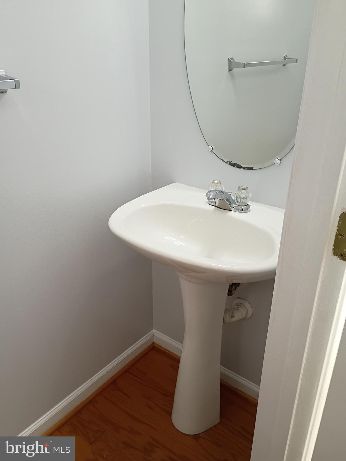 9707 Selfridge Road Baltimore, MD 21220 - Photo 6 of 22 a bathroom with a sink and mirror