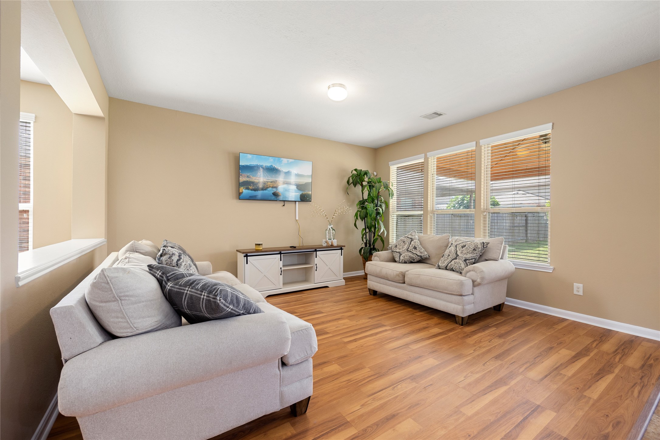 22414 Bellwick Ridge Lane Katy, TX 77449 - Photo 5 of 16 Bright and inviting living room with cozy seating and ample natural light from large windows.