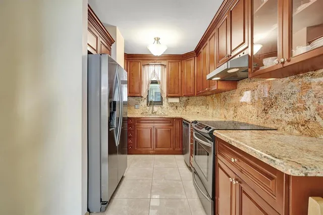 a kitchen with a sink stove and cabinets