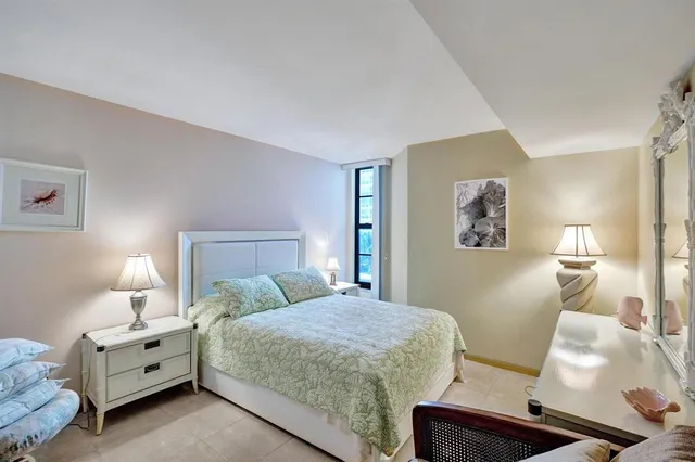 a bedroom with a bed and lamp