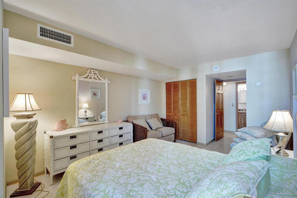 1000 South Ocean Boulevard, Unit 6M Pompano Beach, FL 33062 - Photo 17 of 31 a spacious bedroom with a bed and a lamp