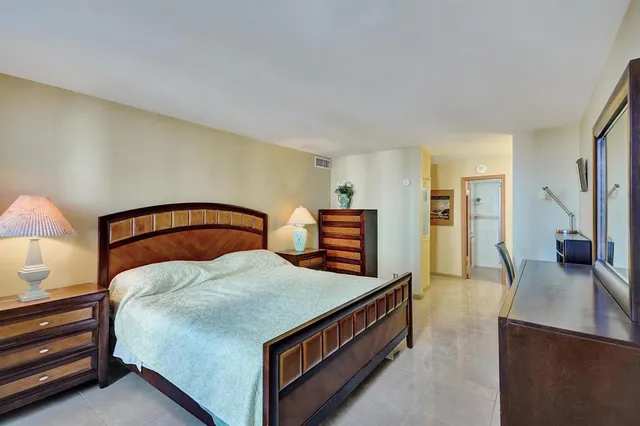 a bedroom with bed and wooden floor