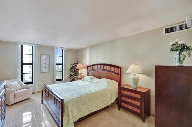 a bedroom with a large bed and a couch