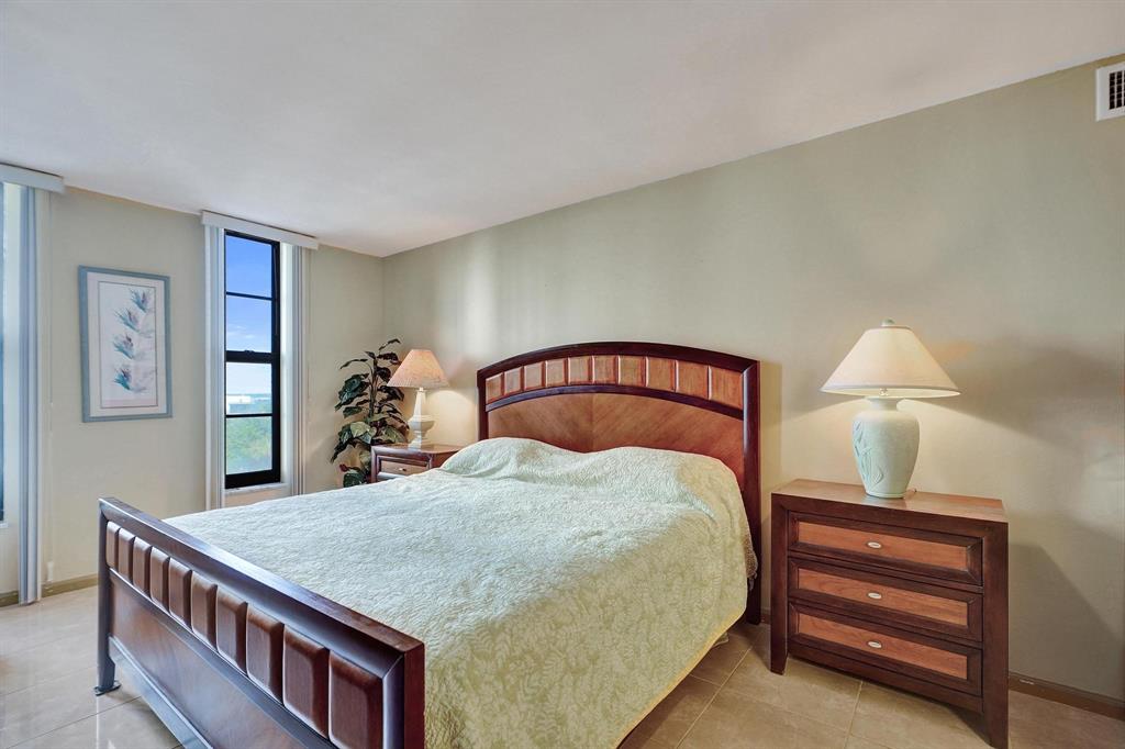 1000 South Ocean Boulevard, Unit 6M Pompano Beach, FL 33062 - Photo 22 of 31 a bedroom with a bed and a chandelier