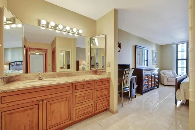 a spacious en suite bathroom with double sink and a large mirror