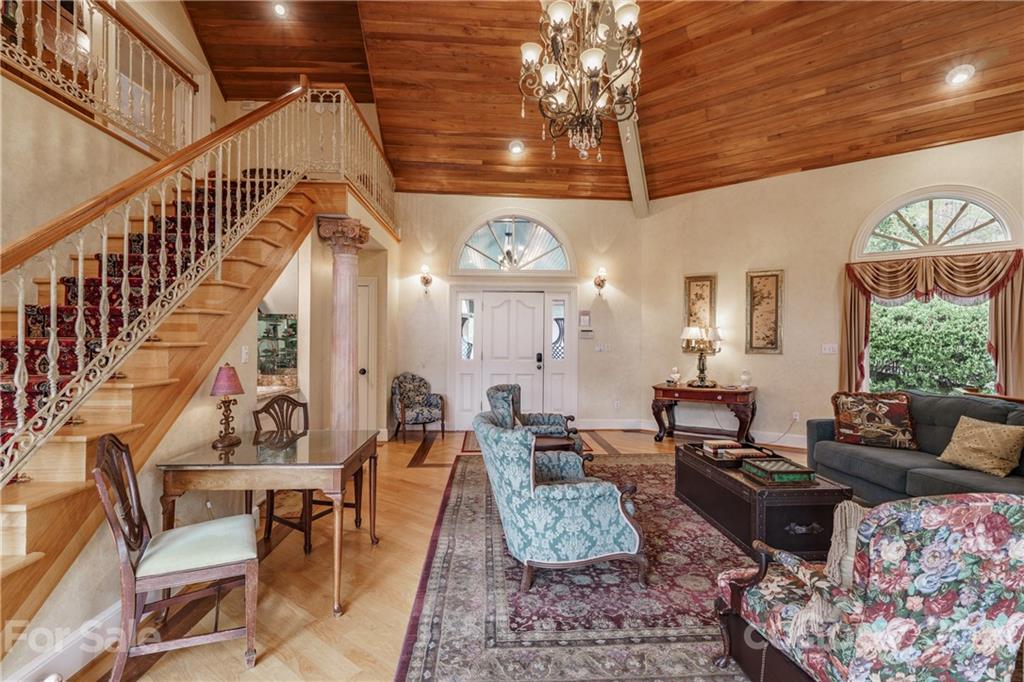 454 Cut Away Road Lake Lure, NC 28746 - Photo 24 of 48 a living room with lots of furniture and a chandelier