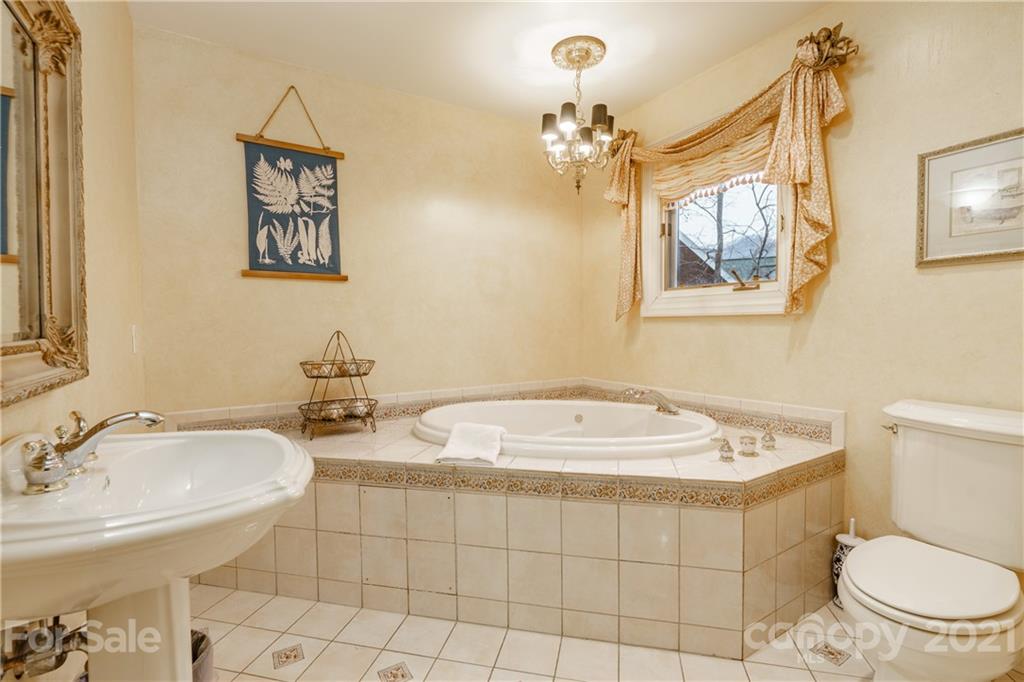 454 Cut Away Road Lake Lure, NC 28746 - Photo 34 of 48 a bathroom with a toilet sink and mirror