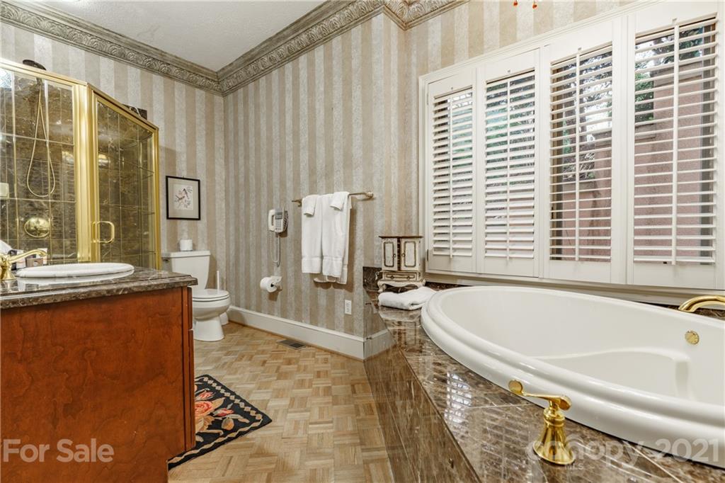 454 Cut Away Road Lake Lure, NC 28746 - Photo 36 of 48 a spacious bathroom with a granite countertop tub and a sink