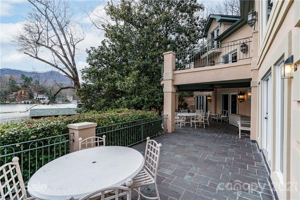 454 Cut Away Road Lake Lure, NC 28746 - Photo 10 of 48 a view of a chair and tables in the balcony