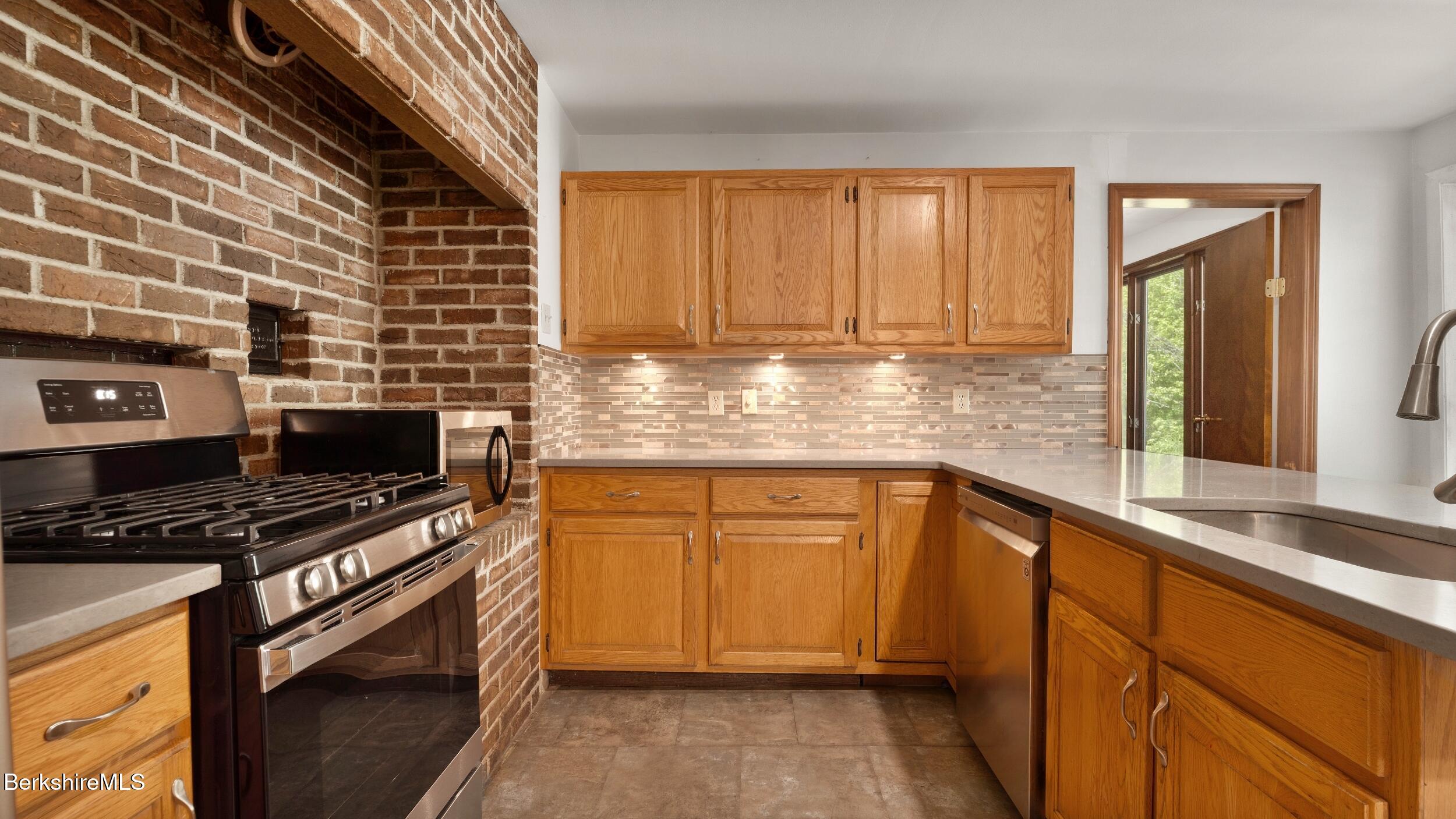 20 East Dugway Road Lenox, MA 01240 - Photo 10 of 84 a kitchen with stainless steel appliances a stove sink and cabinets