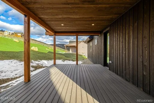 a view of a balcony with wooden floor
