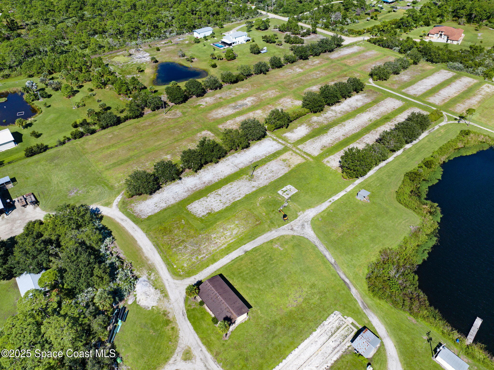 A Berry Road Grant Valkaria, FL 32949 - Photo 23 of 46 a view of a tennis ground with a large pool