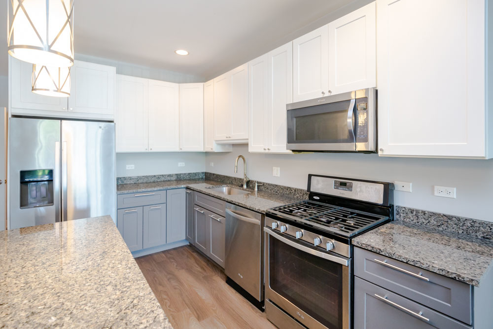 1202 Waukegan Road, Unit 410 Glenview, IL 60025 - Photo 2 of 15 a kitchen with stainless steel appliances granite countertop a stove microwave sink and refrigerator