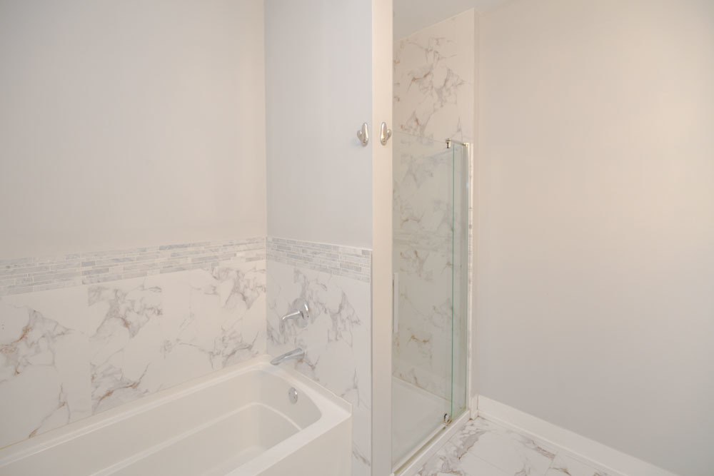 1202 Waukegan Road, Unit 410 Glenview, IL 60025 - Photo 7 of 15 a bathroom with a bathtub