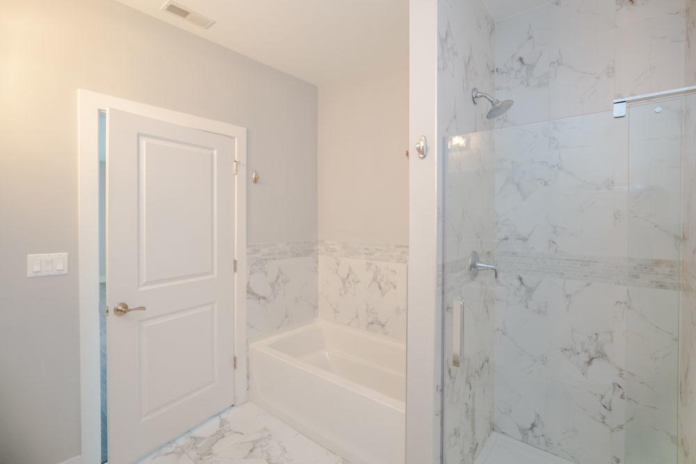 1202 Waukegan Road, Unit 410 Glenview, IL 60025 - Photo 8 of 15 a bathroom with a bathtub