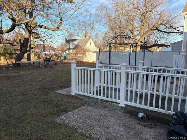 a view of a chair and table in the backyard