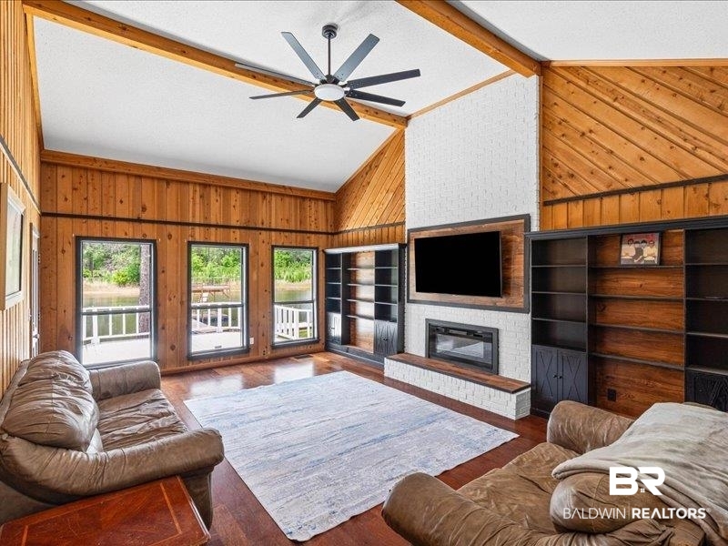 3160 Old Castleberry Road Brewton, AL 36426 - Photo 4 of 36 Spacious living area featuring a vaulted ceiling with exposed beams, wood-finish flooring, and natural wood paneling